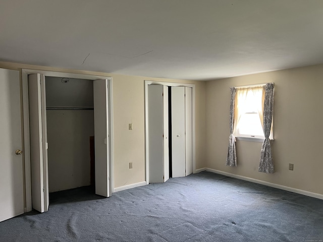 284 Gilbert Ave, Winchester, CT 06098 - unfurnished bedroom featuring multiple closets, carpet, and baseboards