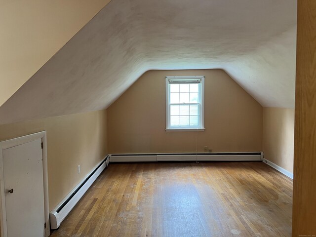 284 Gilbert Ave, Winchester, CT 06098 - bonus room with a baseboard heating unit, wood finished floors, baseboard heating, lofted ceiling, and baseboards