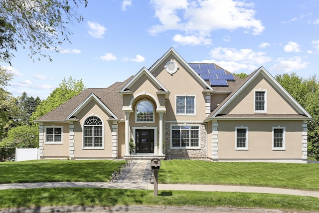 81 Aresco Dr, Middletown, CT 06457 - traditional-style home featuring stucco siding, solar panels, a front yard, and stone siding