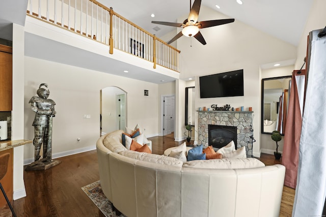81 Aresco Dr, Middletown, CT 06457 - living area with high vaulted ceiling, a ceiling fan, arched walkways, wood finished floors, and a fireplace