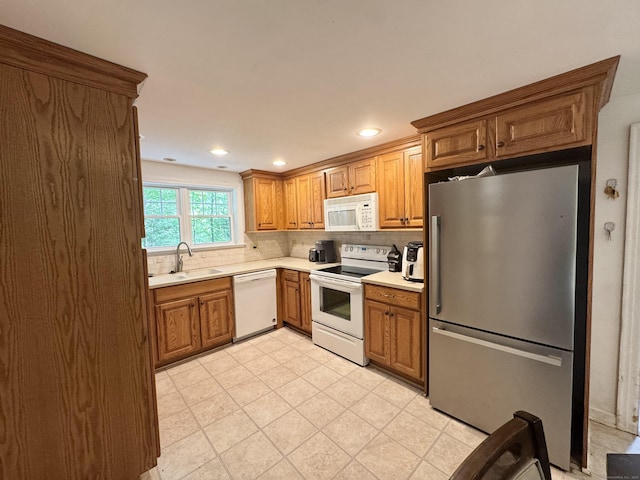 87 Munson Rd, Beacon Falls, CT 06403 - kitchen with white appliances, a sink, light countertops, backsplash, and brown cabinetry