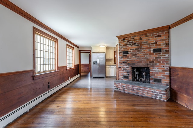 8 Southbury Rd, Roxbury, CT 06783 - unfurnished living room featuring a baseboard radiator, hardwood / wood-style floors, a wainscoted wall, wood walls, and ornamental molding