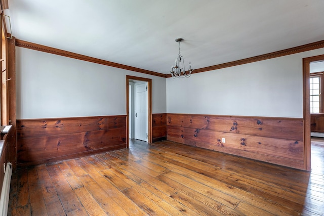8 Southbury Rd, Roxbury, CT 06783 - empty room featuring wainscoting, hardwood / wood-style floors, a chandelier, ornamental molding, and wood walls