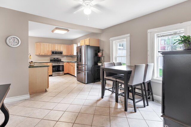 16 Hodge Ave, Ansonia, CT 06401 - kitchen with light brown cabinets, appliances with stainless steel finishes, a ceiling fan, light tile patterned flooring, and baseboards