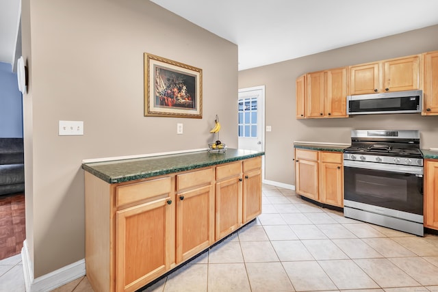 16 Hodge Ave, Ansonia, CT 06401 - kitchen featuring stainless steel appliances, light brown cabinets, dark countertops, and baseboards