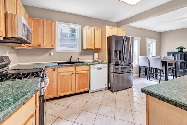 16 Hodge Ave, Ansonia, CT 06401 - kitchen with stainless steel appliances, a sink, light brown cabinetry, dark countertops, and light tile patterned floors