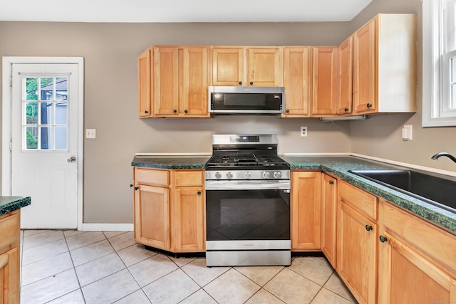 16 Hodge Ave, Ansonia, CT 06401 - kitchen featuring appliances with stainless steel finishes, a sink, light brown cabinets, and dark countertops