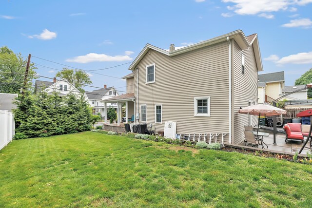 16 Hodge Ave, Ansonia, CT 06401 - back of house with a patio, outdoor lounge area, and a chimney
