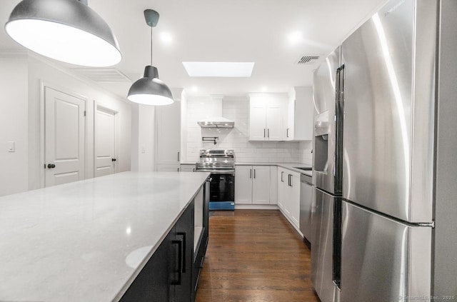 24 Linde St, West Haven, CT 06516 - kitchen featuring stainless steel appliances, a skylight, tasteful backsplash, dark wood-style floors, and white cabinetry