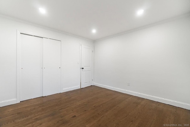 24 Linde St, West Haven, CT 06516 - unfurnished bedroom with ornamental molding, dark wood finished floors, baseboards, and a closet