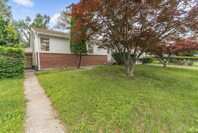24 Linde St, West Haven, CT 06516 - view of property exterior with a yard and brick siding