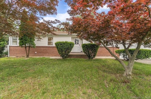 24 Linde St, West Haven, CT 06516 - view of property hidden behind natural elements with a front lawn and brick siding