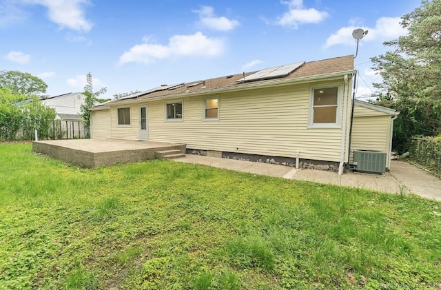 24 Linde St, West Haven, CT 06516 - back of property with a patio, central AC unit, solar panels, and a lawn