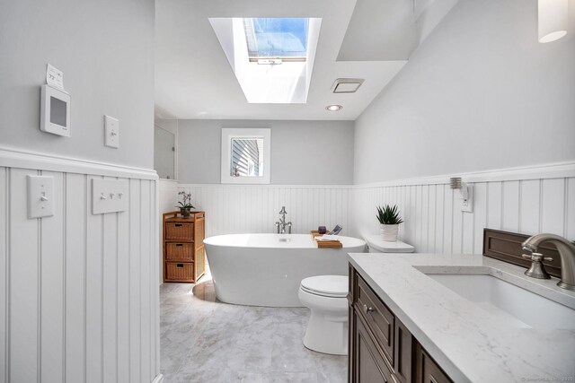 35 Deer Hill Ave, Danbury, CT 06810 - full bath featuring a freestanding tub, a skylight, wainscoting, vanity, and toilet