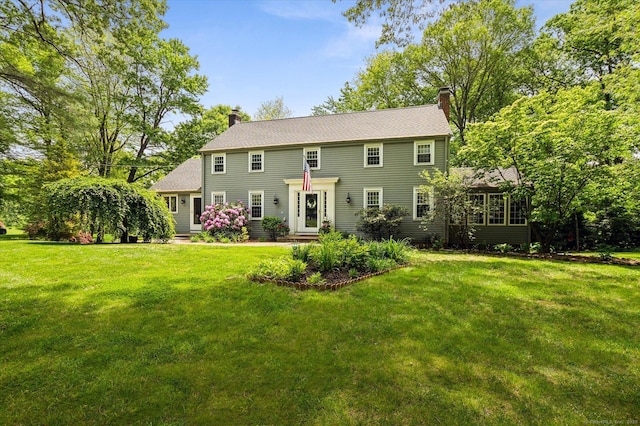 8 Buttonwood Dr, Simsbury, CT 06070 - rear view of house featuring a chimney and a lawn
