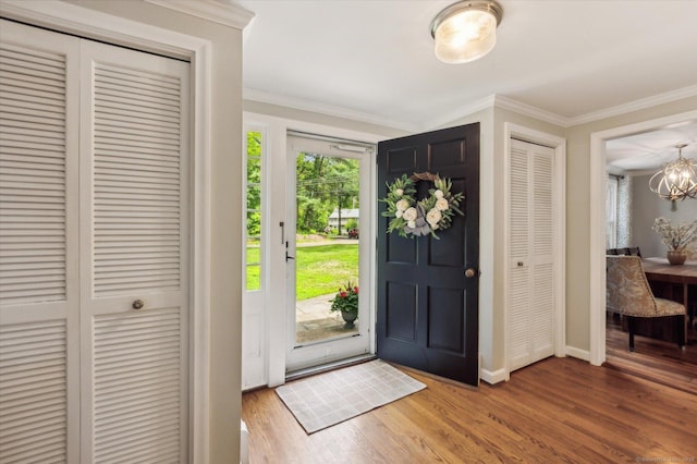 8 Buttonwood Dr, Simsbury, CT 06070 - foyer featuring plenty of natural light, a chandelier, ornamental molding, and wood finished floors