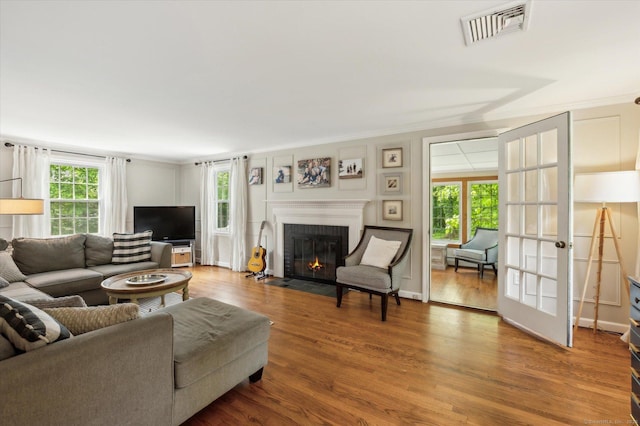 8 Buttonwood Dr, Simsbury, CT 06070 - living area with a brick fireplace, wood finished floors, and ornamental molding