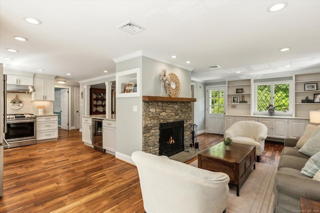 8 Buttonwood Dr, Simsbury, CT 06070 - living area featuring wood-type flooring, beverage cooler, recessed lighting, a fireplace, and ornamental molding