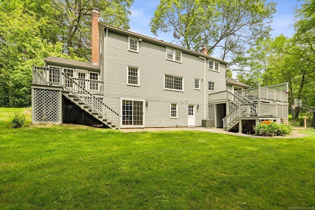 8 Buttonwood Dr, Simsbury, CT 06070 - back of property featuring stairway, a chimney, a deck, and a lawn