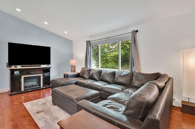 8 High Meadow Ln, Enfield, CT 06082 - living area featuring wood finished floors, recessed lighting, a glass covered fireplace, and lofted ceiling