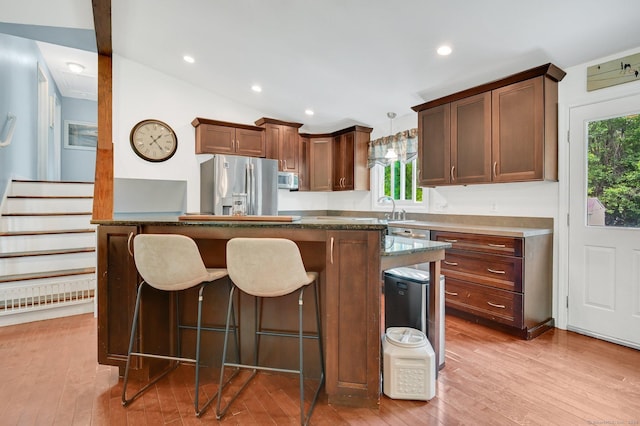8 High Meadow Ln, Enfield, CT 06082 - kitchen featuring stainless steel fridge, plenty of natural light, light wood-style floors, a breakfast bar, and recessed lighting
