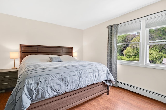 8 High Meadow Ln, Enfield, CT 06082 - bedroom featuring baseboard heating and wood finished floors