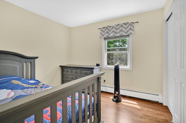 8 High Meadow Ln, Enfield, CT 06082 - bedroom featuring a baseboard radiator and wood finished floors