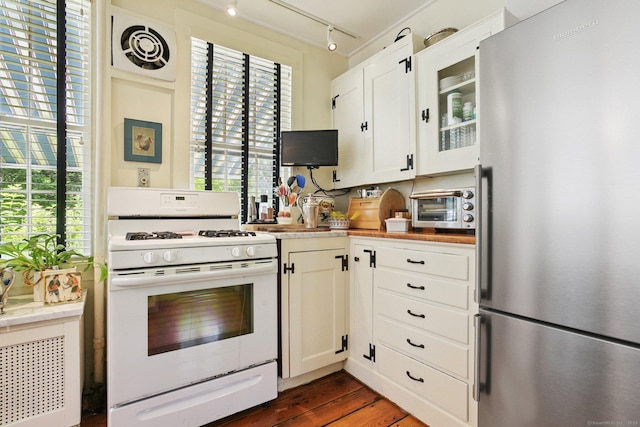 2 Summit St, Stonington, CT 06378 - kitchen with freestanding refrigerator, white gas range, rail lighting, glass insert cabinets, and dark wood-style flooring