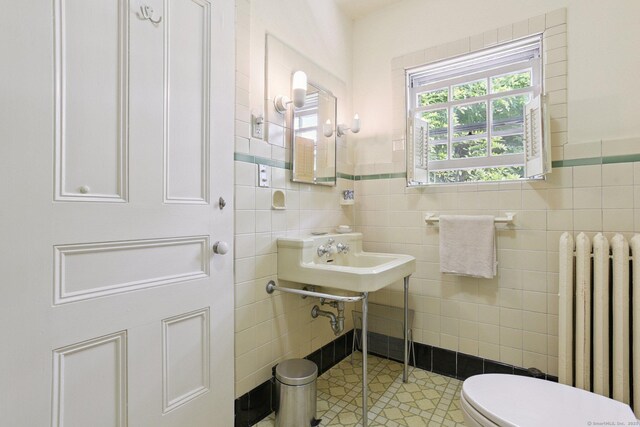 2 Summit St, Stonington, CT 06378 - half bath featuring radiator heating unit, tile walls, tile patterned flooring, and wainscoting