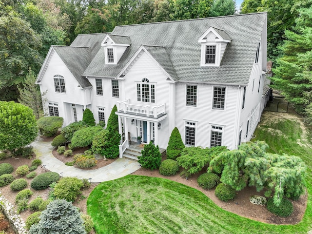 249 Sturges Hwy, Westport, CT 06880 - view of front of house with a balcony, view of wooded area, and a shingled roof