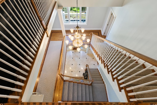 249 Sturges Hwy, Westport, CT 06880 - stairway with a chandelier and baseboards