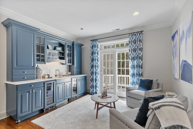 249 Sturges Hwy, Westport, CT 06880 - living room featuring beverage cooler, bar with sink, ornamental molding, dark wood finished floors, and recessed lighting