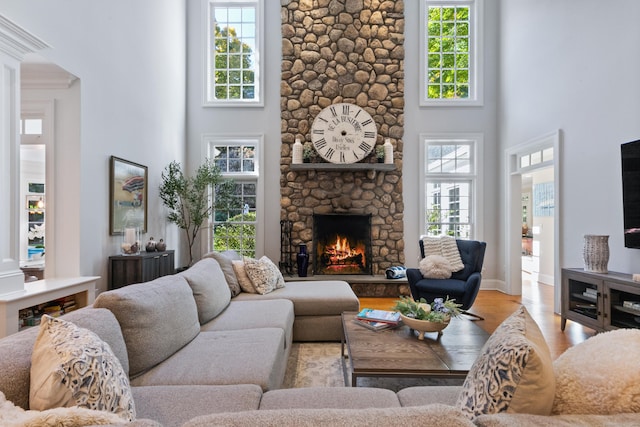249 Sturges Hwy, Westport, CT 06880 - living room with a towering ceiling, wood finished floors, a fireplace, and arched walkways