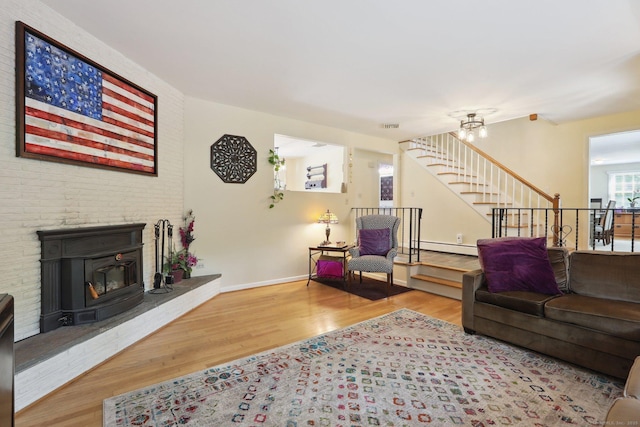 81 Park Rd, Woodbury, CT 06798 - living area with wood finished floors, stairs, a baseboard heating unit, baseboards, and a chandelier