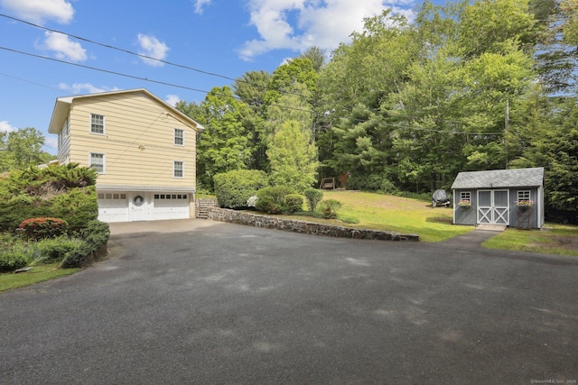 81 Park Rd, Woodbury, CT 06798 - view of property exterior featuring asphalt driveway, an attached garage, and a lawn