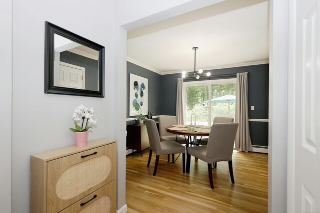 28 Shields Ln, Ridgefield, CT 06877 - dining room with crown molding, a baseboard radiator, light wood-style floors, and a chandelier