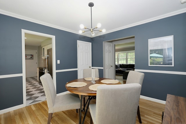 28 Shields Ln, Ridgefield, CT 06877 - dining room featuring a chandelier, crown molding, baseboards, and light wood-type flooring