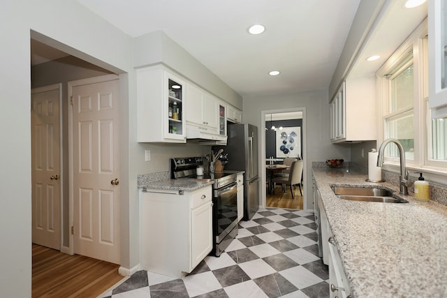 28 Shields Ln, Ridgefield, CT 06877 - kitchen featuring stainless steel electric range, a sink, under cabinet range hood, white cabinetry, and glass insert cabinets