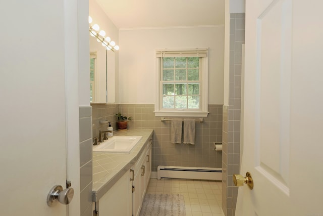 28 Shields Ln, Ridgefield, CT 06877 - bathroom with baseboard heating, tile walls, vanity, tile patterned floors, and crown molding