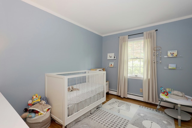 28 Shields Ln, Ridgefield, CT 06877 - bedroom with wood finished floors, crown molding, a nursery area, and a baseboard radiator