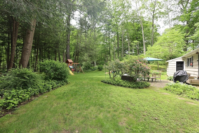 28 Shields Ln, Ridgefield, CT 06877 - view of grassy yard featuring a patio area and a playground