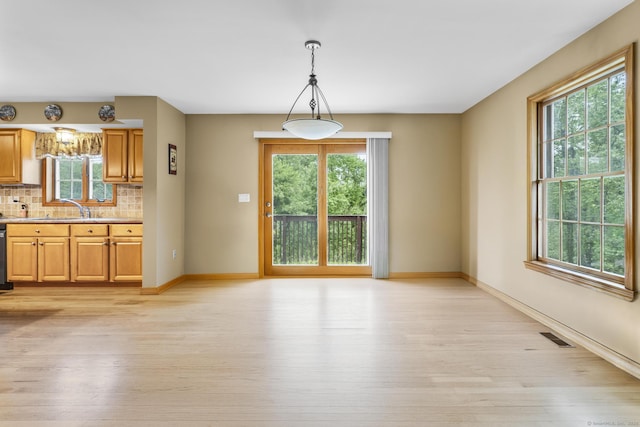 290 Amity Rd, Bethany, CT 06524 - unfurnished dining area with light wood-style flooring, baseboards, and a sink