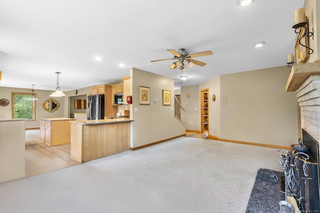 290 Amity Rd, Bethany, CT 06524 - kitchen featuring freestanding refrigerator, stainless steel microwave, light brown cabinetry, a ceiling fan, and a brick fireplace
