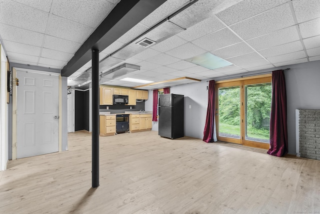 290 Amity Rd, Bethany, CT 06524 - kitchen with black appliances, light brown cabinetry, a paneled ceiling, light wood finished floors, and light countertops