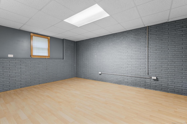 290 Amity Rd, Bethany, CT 06524 - unfurnished room with brick wall, a drop ceiling, and wood finished floors