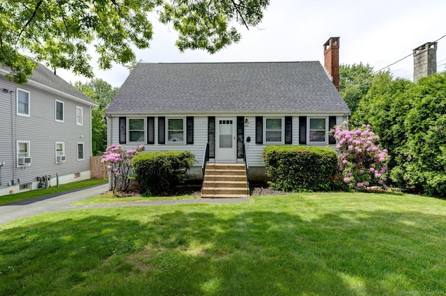 394 Mcclintock St, New Britain, CT 06053 - cape cod-style house featuring a front lawn, roof with shingles, a chimney, and cooling unit