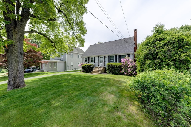 394 Mcclintock St, New Britain, CT 06053 - cape cod house featuring a chimney, a front yard, and a shingled roof