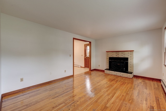 394 Mcclintock St, New Britain, CT 06053 - unfurnished living room with light wood finished floors, a brick fireplace, a baseboard radiator, and baseboards