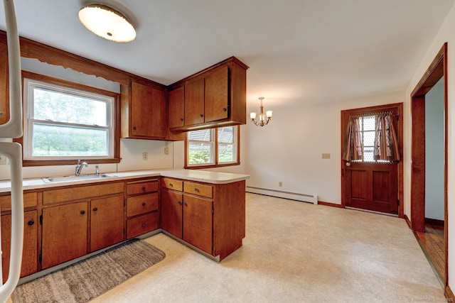 394 Mcclintock St, New Britain, CT 06053 - kitchen with baseboard heating, a sink, light countertops, a peninsula, and brown cabinetry