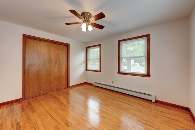 394 Mcclintock St, New Britain, CT 06053 - unfurnished bedroom with a baseboard heating unit, light wood-type flooring, a closet, baseboards, and ceiling fan